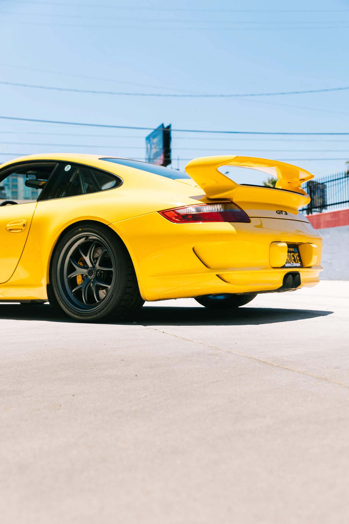 Yellow Porsche 911 GT3 with a large spoiler, wearing Fifteen52 Wheels